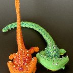 作品ディプロカウルスのフェルトマスコット刺繍ブローチ（オレンジ色のもの）
