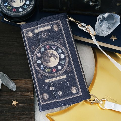 架空の洋書 "誕生石の図鑑" 〜MOON STONE〜 ショルダーストラップ付き 三つ折り手帳型スマホケース / iPhone15